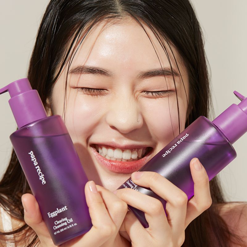 Best K-Beauty Boosters to Transform Your Fall Skincare Routine. Girl holding skincare products.
